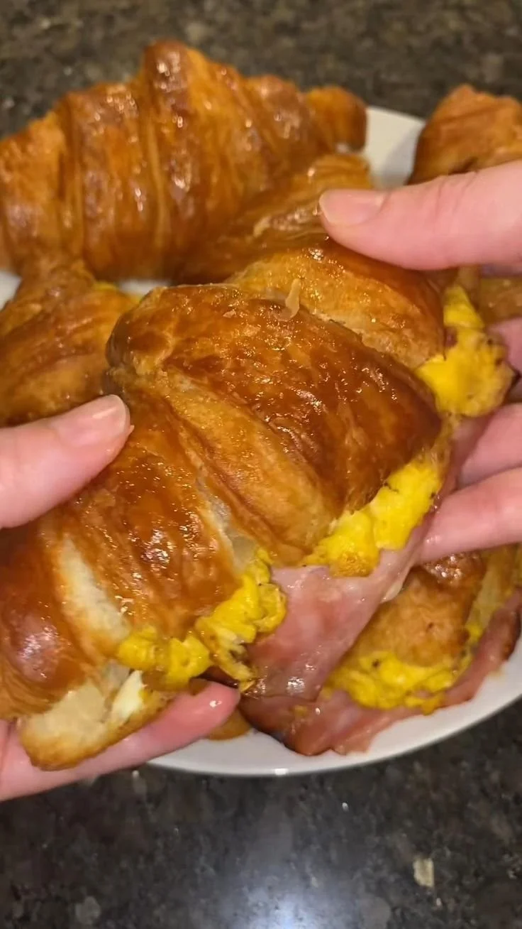 Freshly baked breakfast croissants on a rustic wooden table