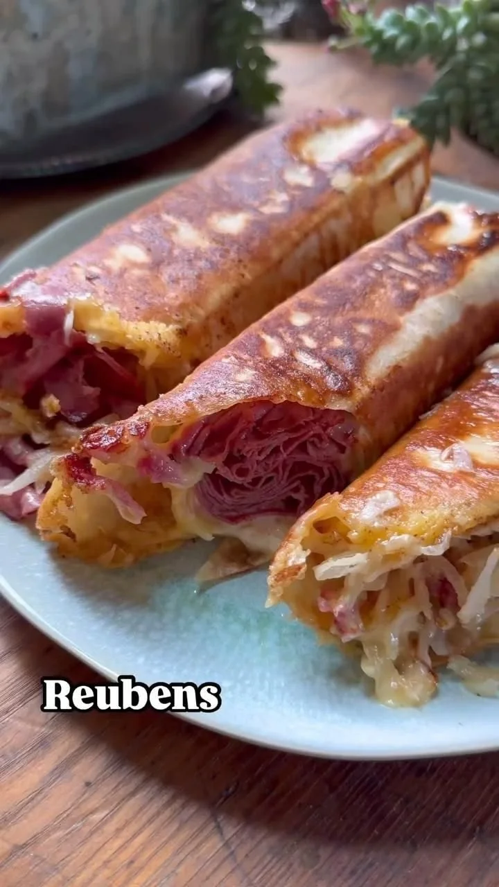 Crispy cheesy Reuben wraps on a plate, ready to enjoy a tasty meal.