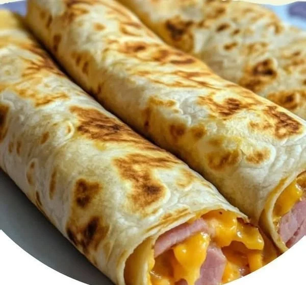Easy air fryer hot ham and cheese wraps served on a plate