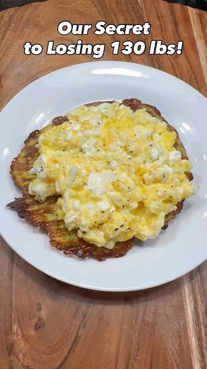 Keto Avocado Egg Bake with baked eggs in halved avocados, garnished with herbs