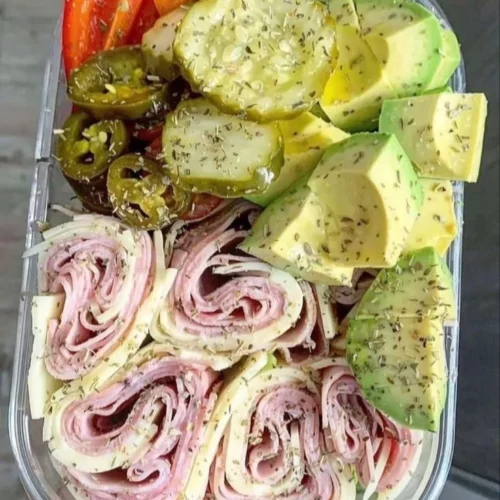 A variety of colorful and nutritious healthy snacks on a wooden platter.
