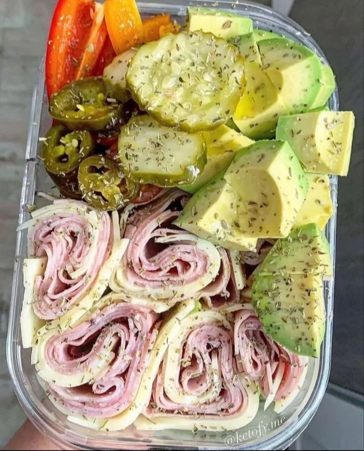A variety of colorful and nutritious healthy snacks on a wooden platter.