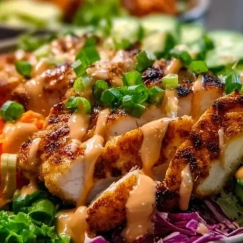 A delicious bowl of Bang Bang Chicken with vibrant vegetables and spicy sauce