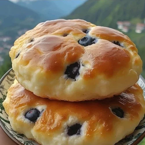 Slice of blueberry cloud bread on a white plate