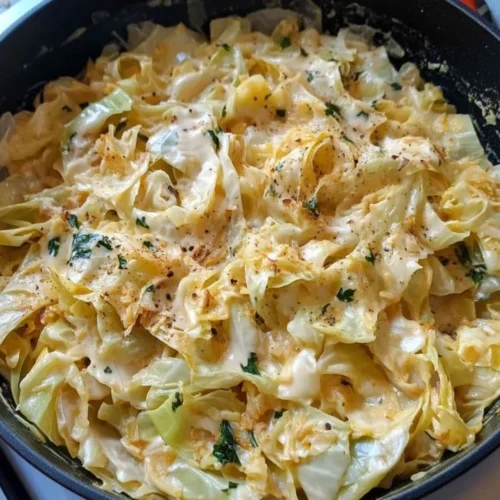 Creamy Cabbage Alfredo served in a bowl with garlic and herbs.
