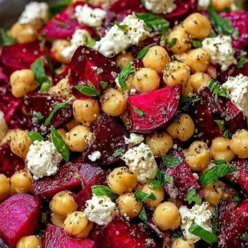 Chickpea, beet, and feta salad in a bowl, showcasing vibrant colors and textures.