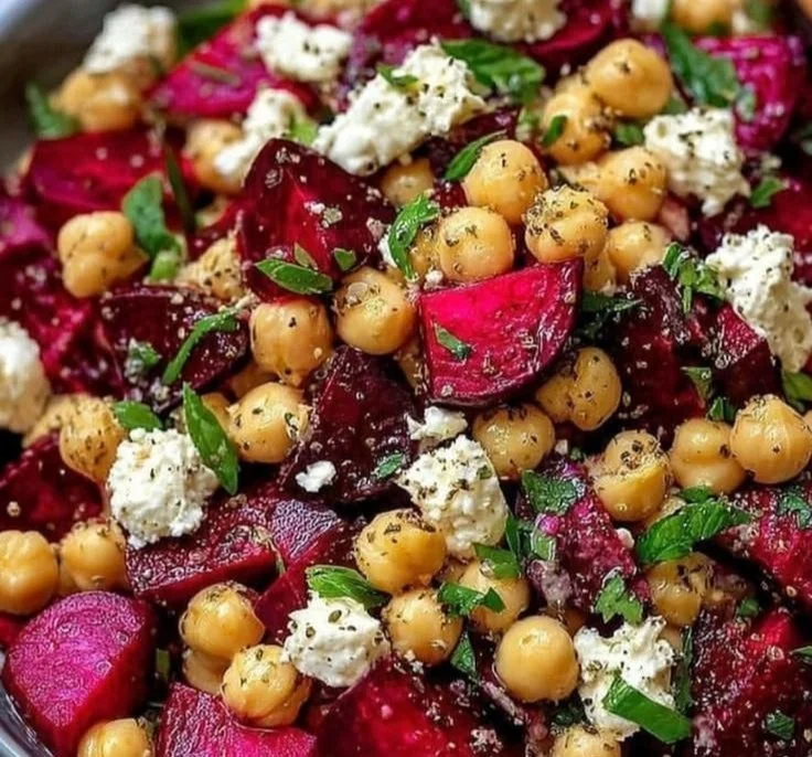Chickpea, beet, and feta salad in a bowl, showcasing vibrant colors and textures.