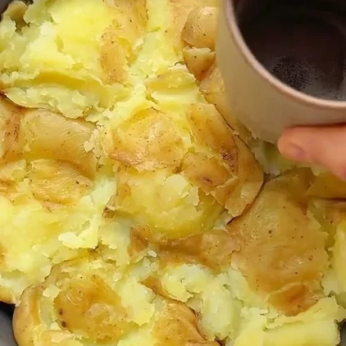 Crispy smashed potatoes pizza topped with herbs and cheese