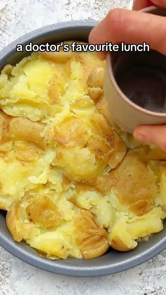 Crispy smashed potatoes pizza topped with herbs and cheese