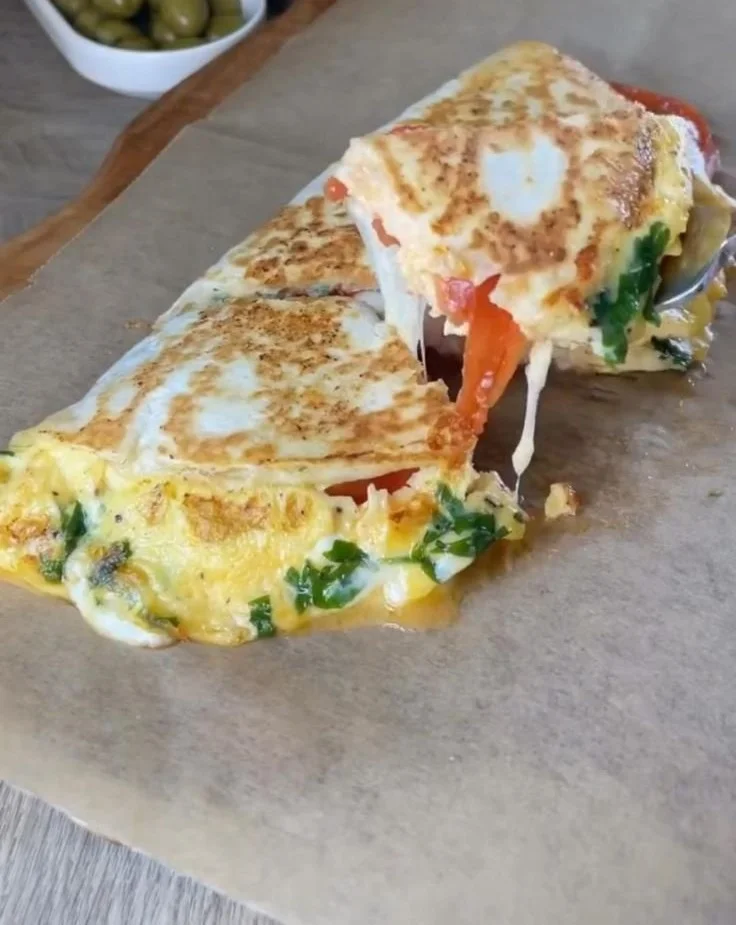 Delicious easy breakfast wrap filled with eggs, veggies, and cheese