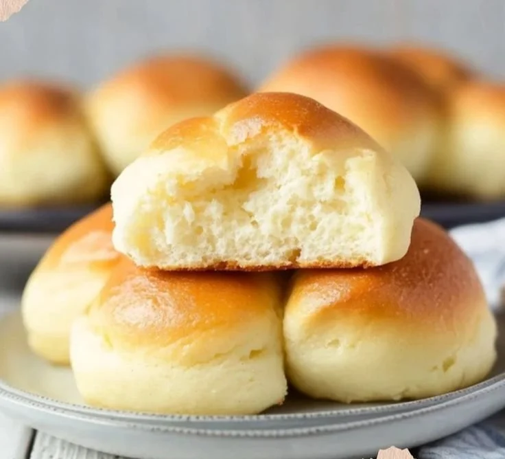 Fluffy cottage cheese cloud bread fresh out of the oven on a baking sheet.