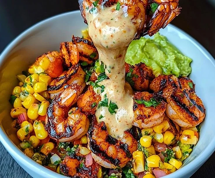Grilled shrimp bowl with avocado, corn salsa, and creamy sauce