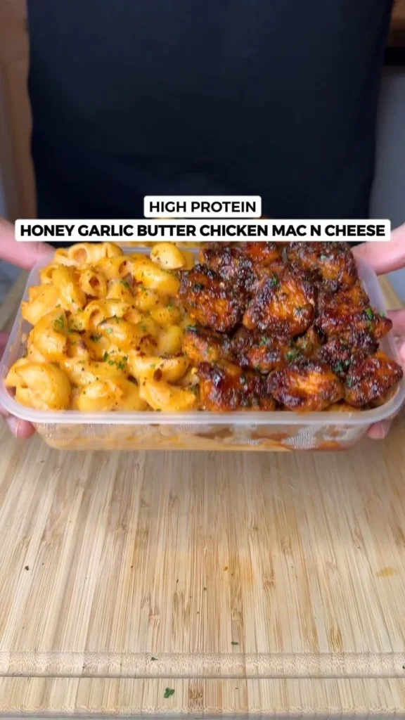 High protein garlic butter chicken mac n cheese dish garnished with herbs
