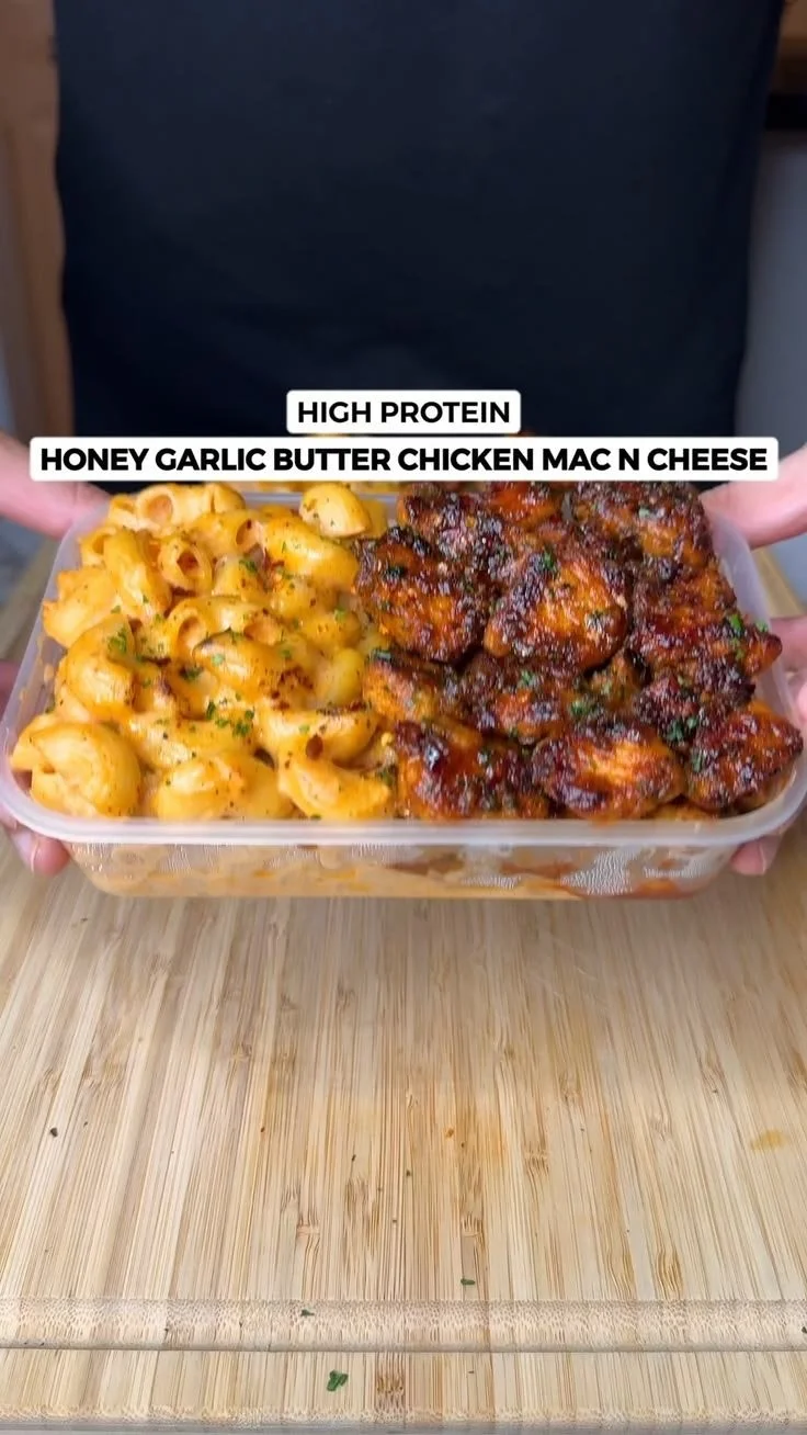 High protein garlic butter chicken mac n cheese dish garnished with herbs