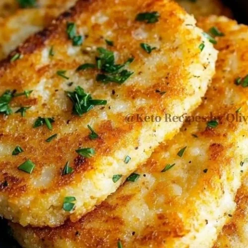 Keto Cauliflower Hash Browns 2 Keto Cauliflower Hash Browns served on a plate with herbs