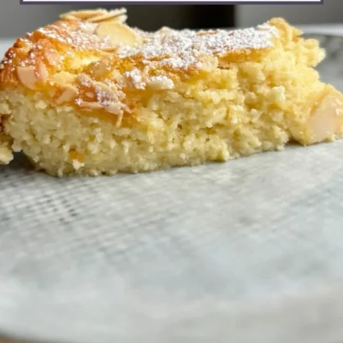 Lemon Almond Cottage Cheese Cake topped with slices of lemon and almonds