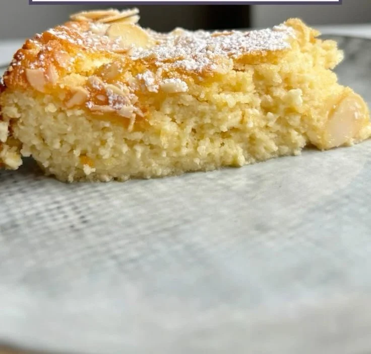 Lemon Almond Cottage Cheese Cake topped with slices of lemon and almonds