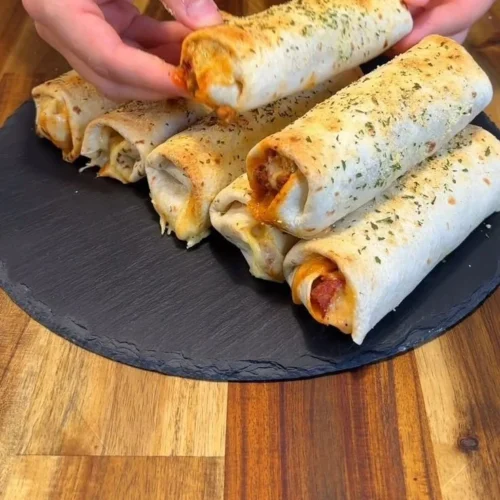 Low-calorie pepperoni pizza rolls on a plate, ideal for a healthy snack.