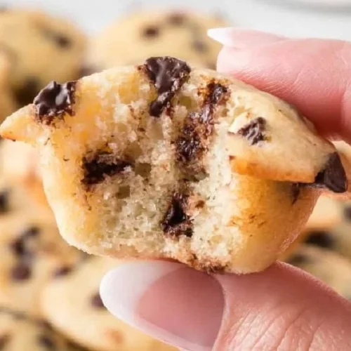 Freshly baked mini chocolate chip muffins on a cooling rack