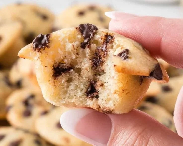 Freshly baked mini chocolate chip muffins on a cooling rack