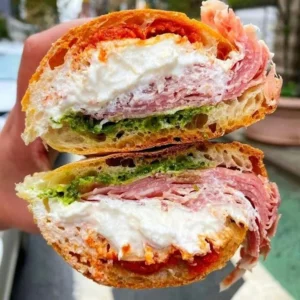A delicious Prosciutto Stracciatella Sandwich with fresh ingredients and creamy cheese.