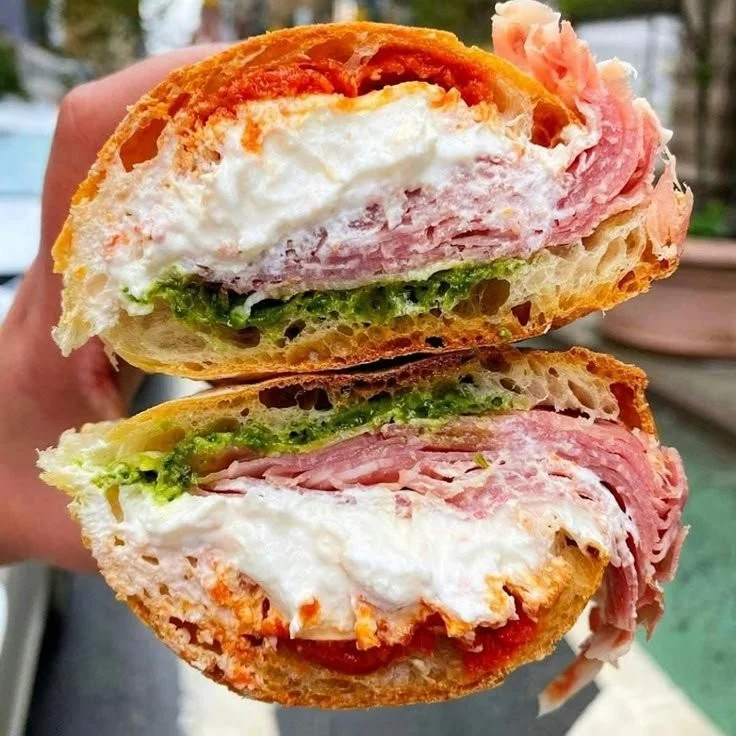A delicious Prosciutto Stracciatella Sandwich with fresh ingredients and creamy cheese.