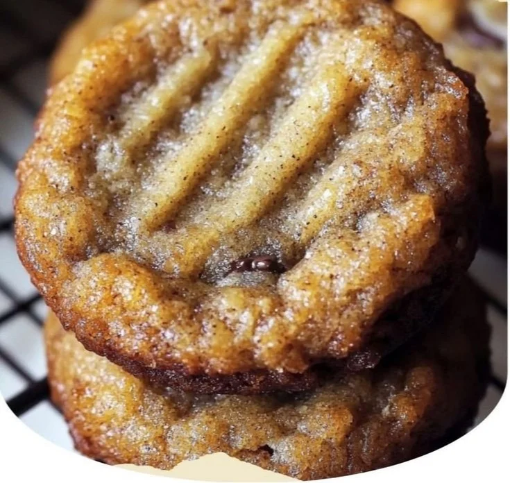 Homemade banana bread cookies displayed on a wooden table with chocolate chips.